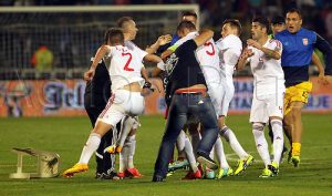 14.10.2014 Belgrade, Serbia. 2016 Euro Qualification match between Serbia and Albania. Lorik Cana(4th from right) Albania fights with a Serbian fan on the field next to Burum Kukeli(3rd from right),Elseid Hysaj(2nd from right) and Zeljko Brkic(r) Serbia: The game was abandoned by FIFA when a drone flew an Albanian flag over the pitch in the 41st minute, which erupted in fights between players and fans alike.