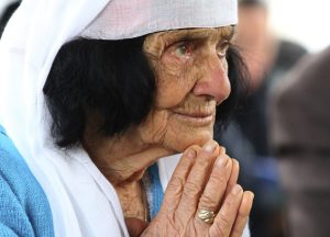 An Albanian woman prays during the mass at the cathedral in the northern city of Shkoder, Albania, celebrating the beatification of 38 Catholic martyrs executed or tortured to death during the former communist regime Saturday, Nov. 5, 2016. Albanians celebrated their beatification after Pope Francis had officially recognized as martyrs Archbishop Vincens Prenushi and 37 other priests who died in prison or were murdered in 1945-1974 by the late communist dictator Enver Hoxha's regime. (AP Photo/Hektor Pustina)